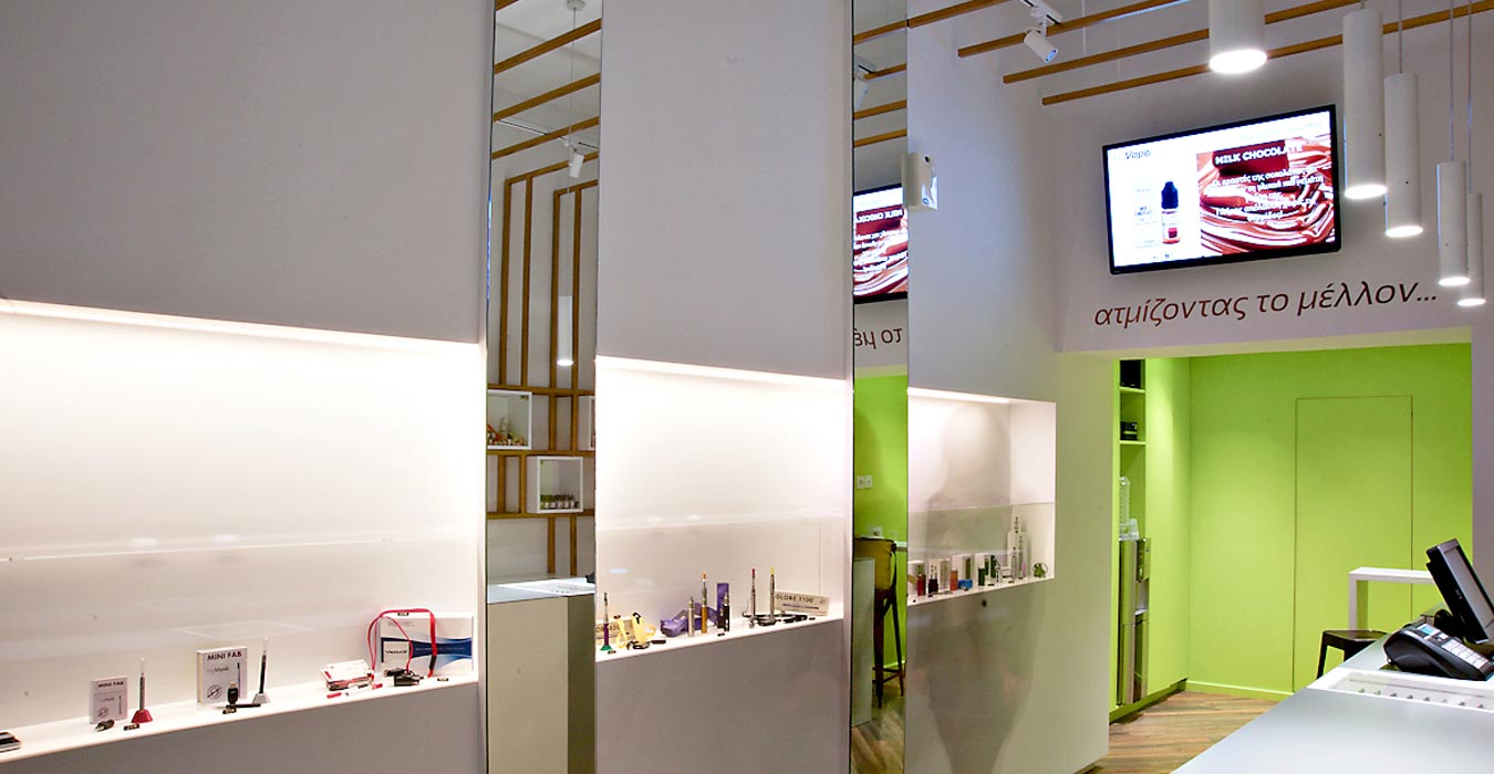 Franchise retail design with minimal cases and vertical mirror surfaces.
